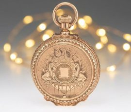 Detailed engraved back of an antique gold pocket watch with ornate vintage craftsmanship
